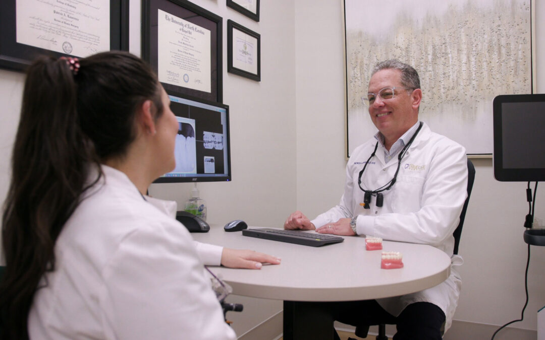 TrueCare Dentistry doctors discussing dental X-rays during a consultation in the office.